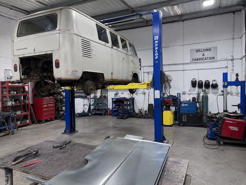Workshop bay at CF3 MOT and Service Centre in Rumney showing the two post lift, MIG welding plant and cutting equipment used for structural corrosion repairs.