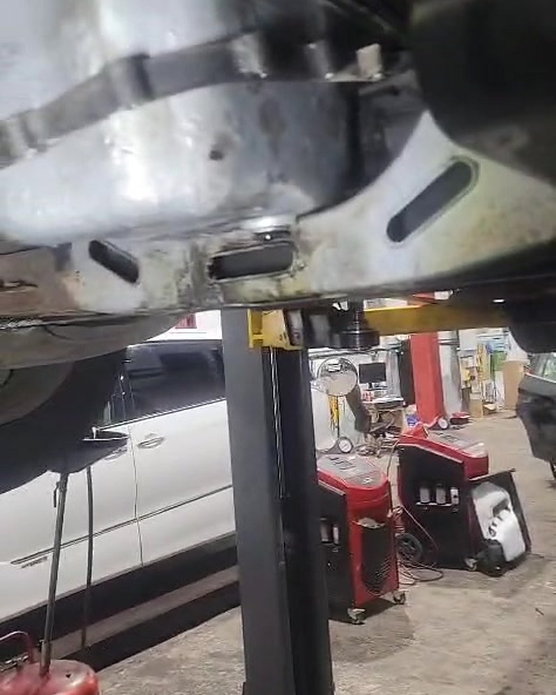 Iveco van raised on a two post lift in the CF3 MOT and Service Centre workshop in Rumney during a timing belt, water pump and sump replacement.